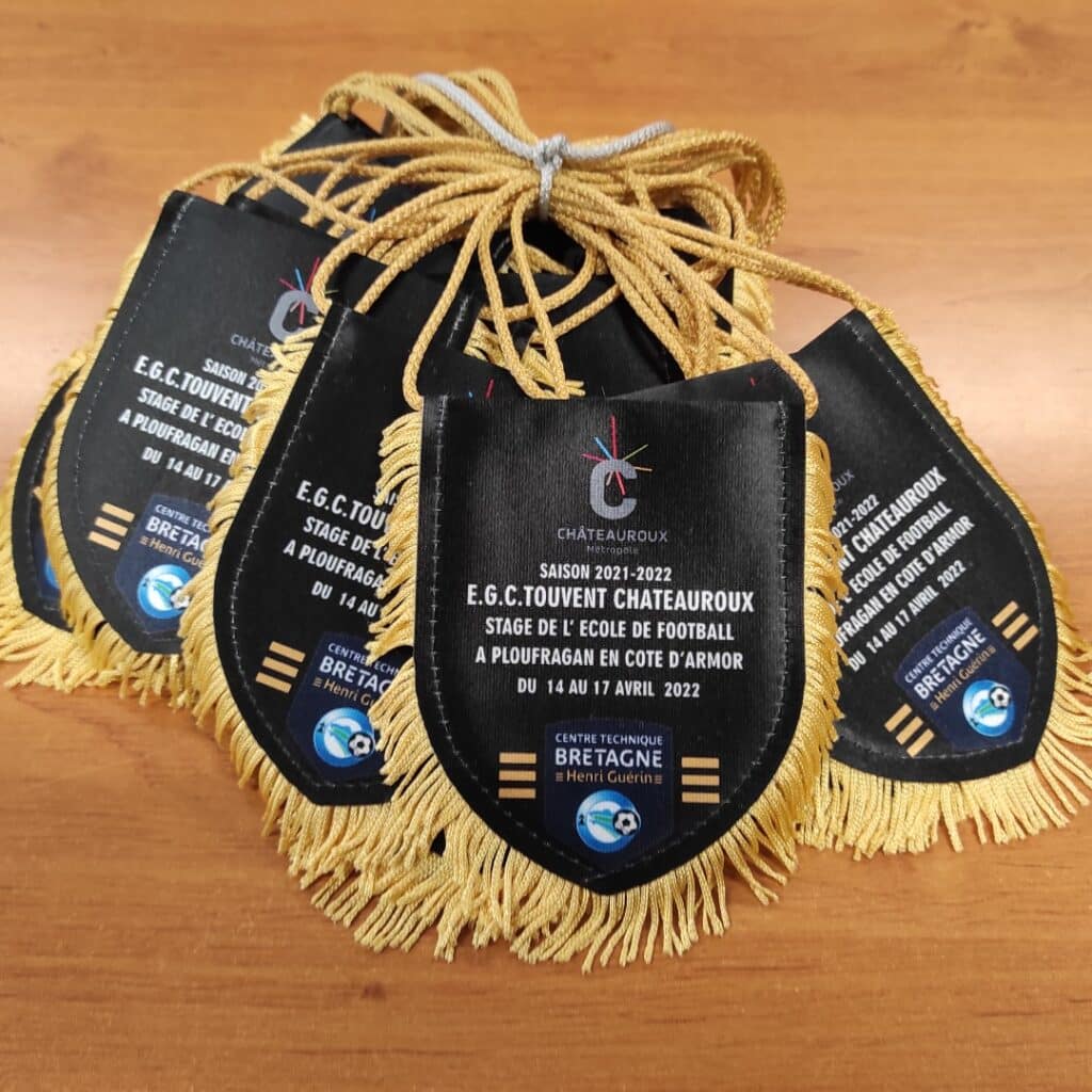 Fanions noirs à franges dorées E.G.C. Touvent Châteauroux pour le stage de football 2022 en Bretagne Henri Guérin.